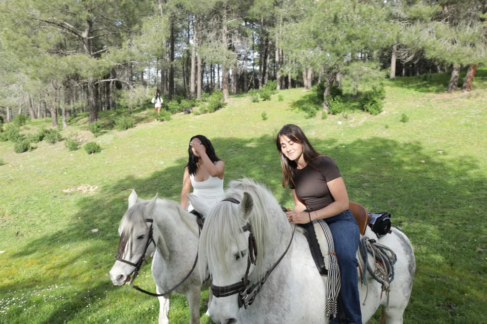 Dos jinetes a caballo en un prado de la Sierra Oeste en Finca El Sarao